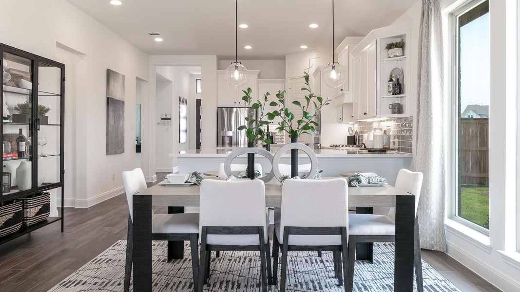 Dining area featuring dark wood-style floors and recessed lighting