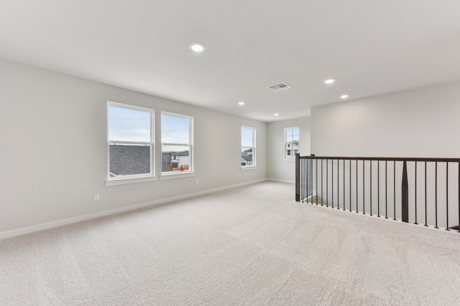 A room with a railing and windows. A room with a railing and windows.