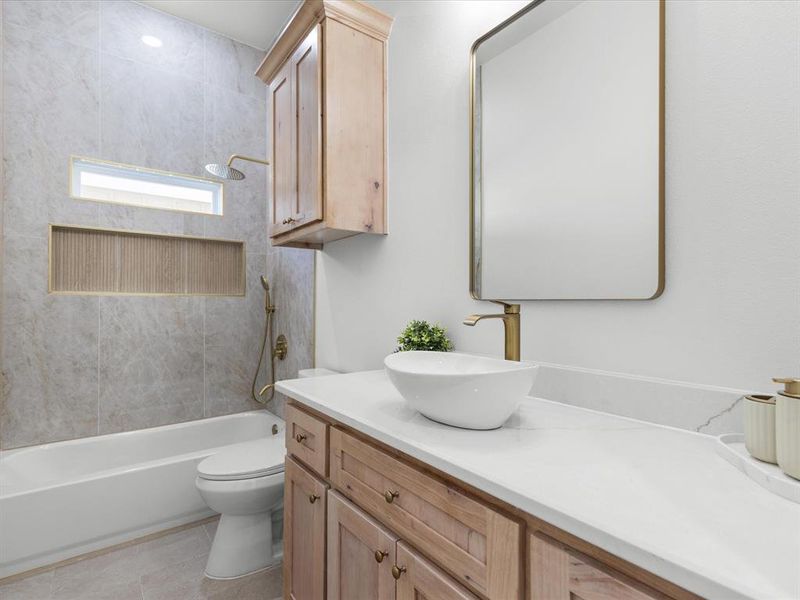 Bathroom with vanity, shower / bath combination, and light tile patterned flooring