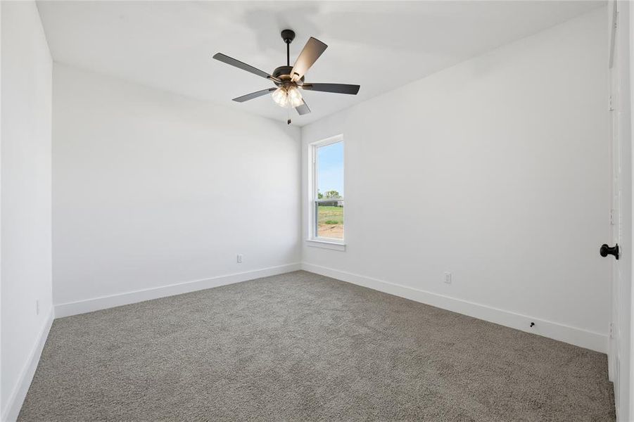 Spare room with carpet and ceiling fan Spare room with carpet and ceiling fan
