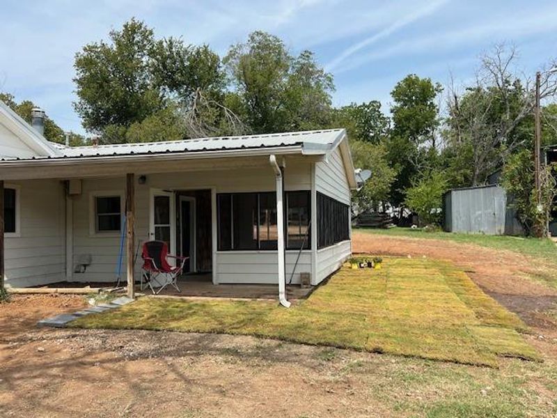 Rear view of house featuring a yard