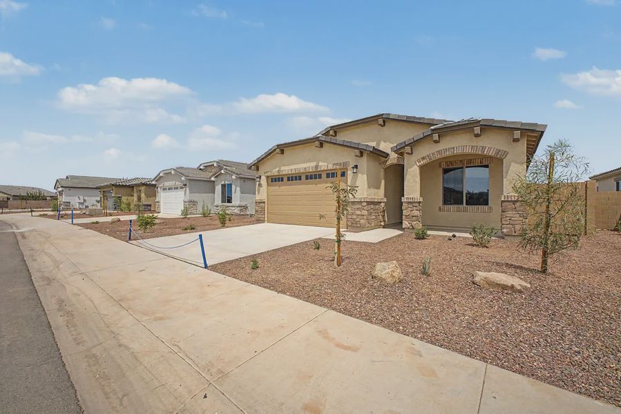 Front exterior of a new home in Avanti at Granite Vista, Waddell, AZ, highlighting curb appeal (Image 21).