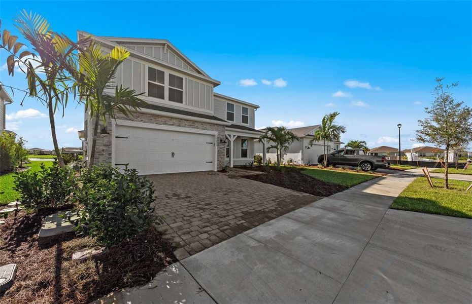 Front exterior of a new home in SeaFlower, Bradenton, FL, highlighting curb appeal (Image 21).