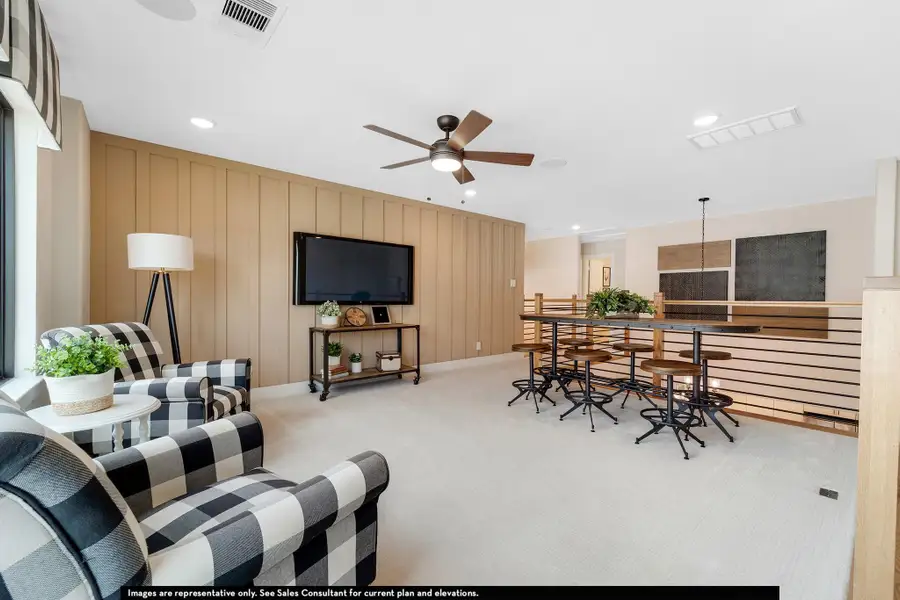 Carpeted living room with recessed lighting and a ceiling fan Carpeted living room with recessed lighting and a ceiling fan