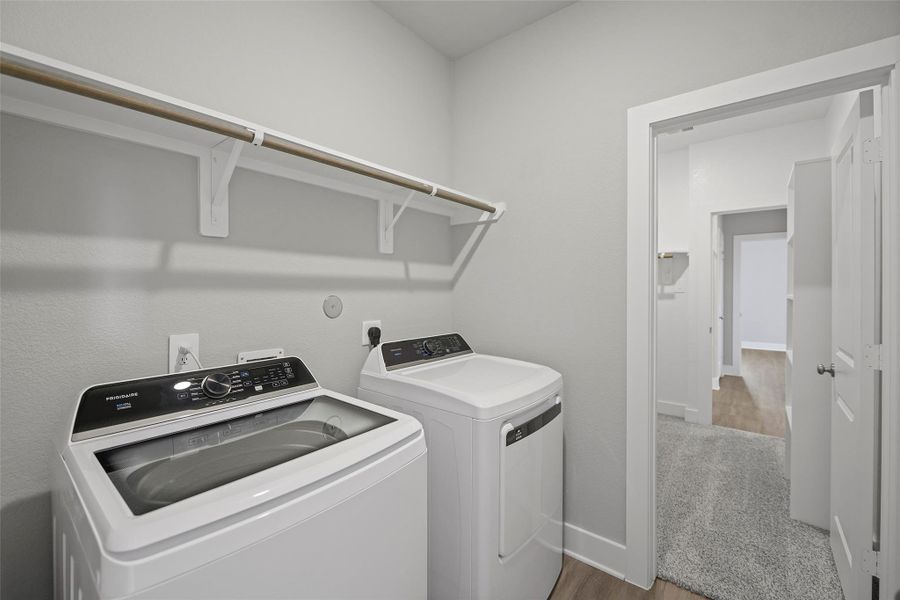 Convenient laundry space with built-in shelving for organization and storage. Convenient laundry space with built-in shelving for organization and storage.
