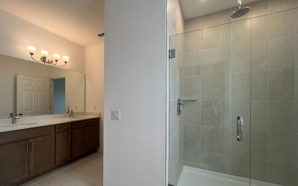Elegant Primary Bathroom with Upgraded Finishes in Central Florida Home Elegant Primary Bathroom with Upgraded Finishes in Central Florida Home