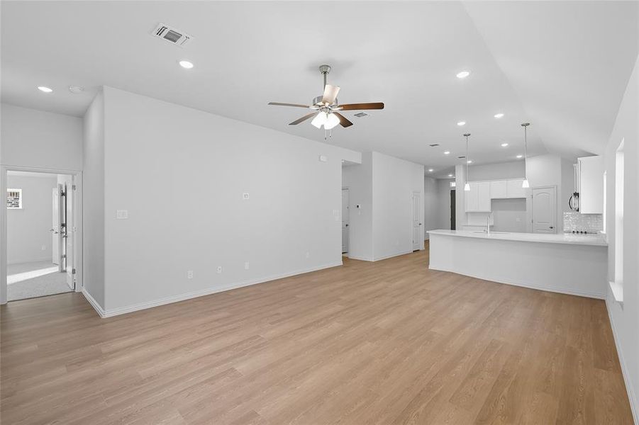 Unfurnished living room featuring light wood-type flooring, recessed lighting, and a ceiling fan Unfurnished living room featuring light wood-type flooring, recessed lighting, and a ceiling fan
