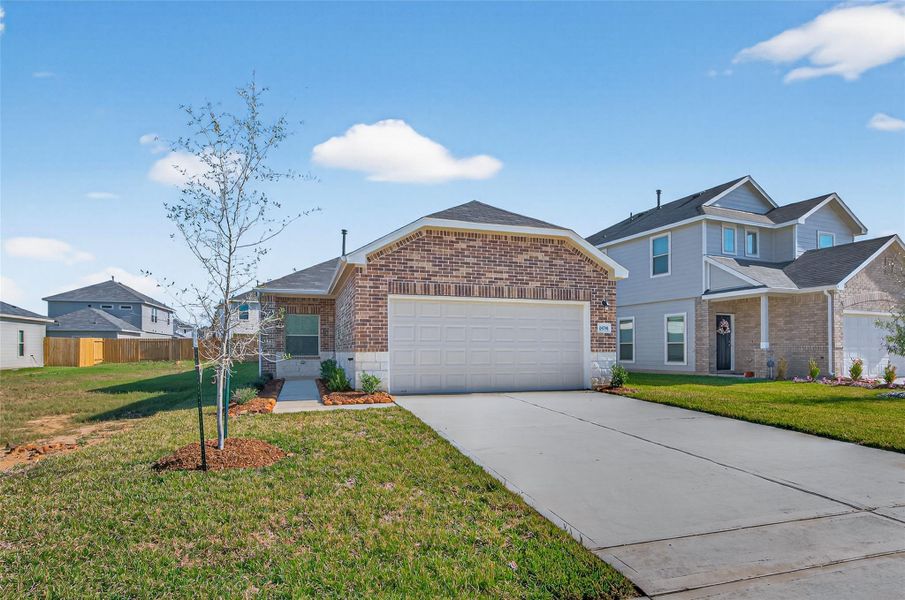 Front exterior of a new home in Woodland Lakes, Huffman, TX, highlighting curb appeal (Image 25).