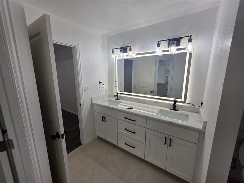 Full bathroom featuring double vanity Full bathroom featuring double vanity