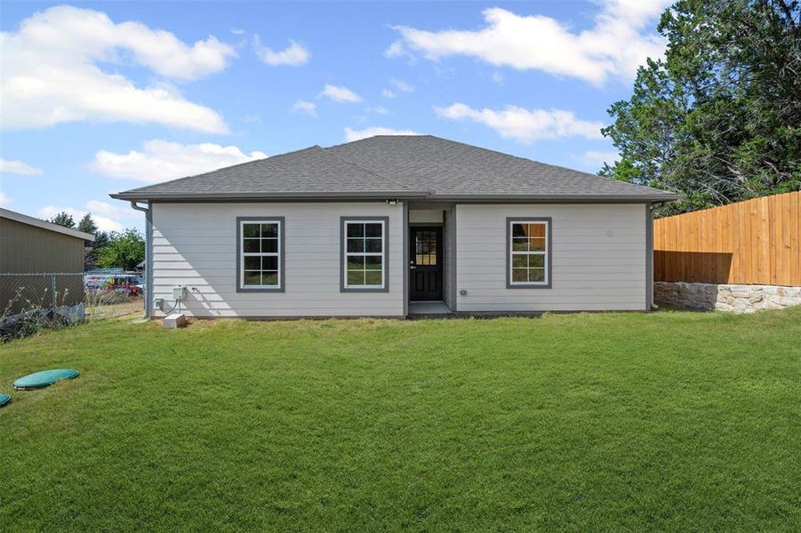 Rear view of property with a shingled roof Rear view of property with a shingled roof