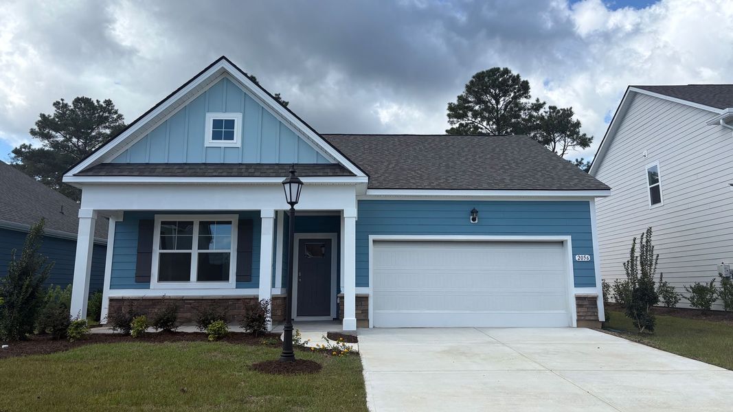 Front exterior of a new home in Brunswick Plantation, Ash, NC, highlighting curb appeal (Image 2). Front exterior of a new home in Brunswick Plantation, Ash, NC, highlighting curb appeal (Image 2).