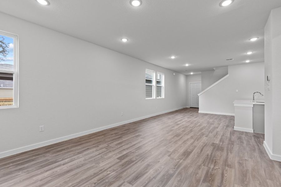 A room with a wood floor and a sink. A room with a wood floor and a sink.