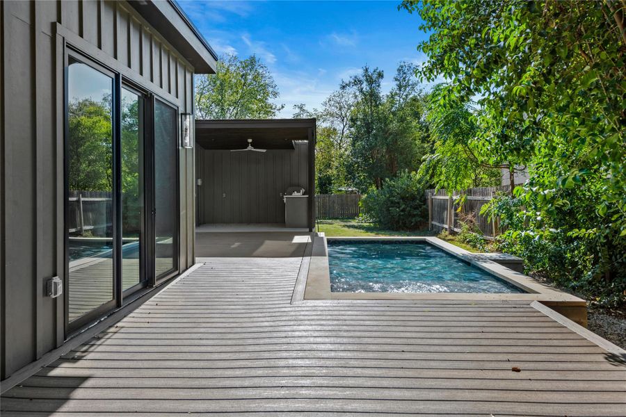 View of swimming pool featuring a fenced backyard, a patio, a ceiling fan, and a deck