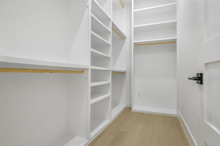 Spacious closet with wood finished floors