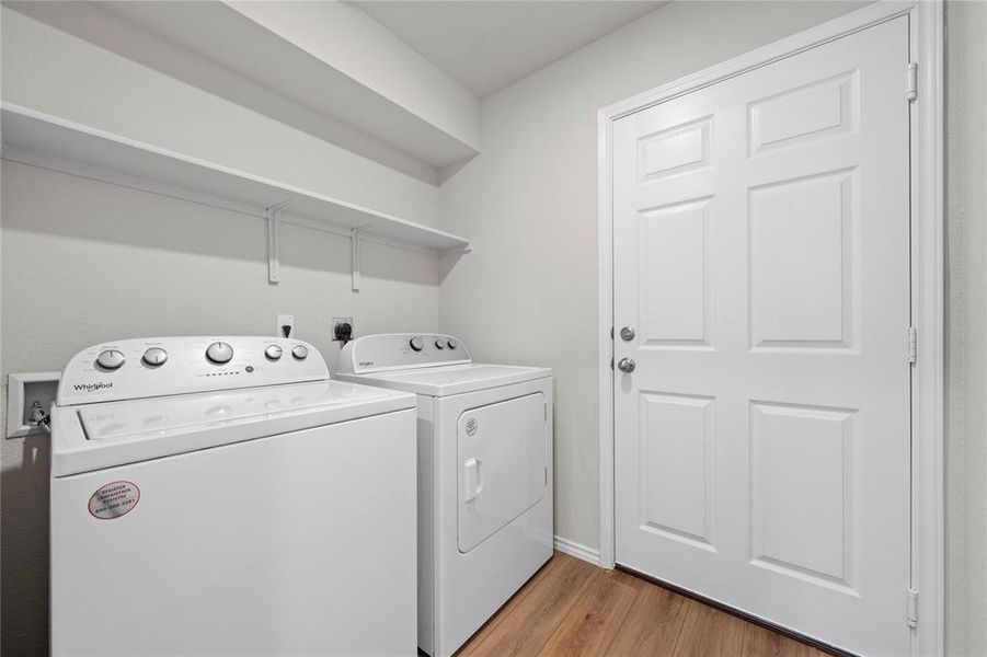 Laundry room featuring light wood-type flooring and independent washer and dryer Laundry room featuring light wood-type flooring and independent washer and dryer