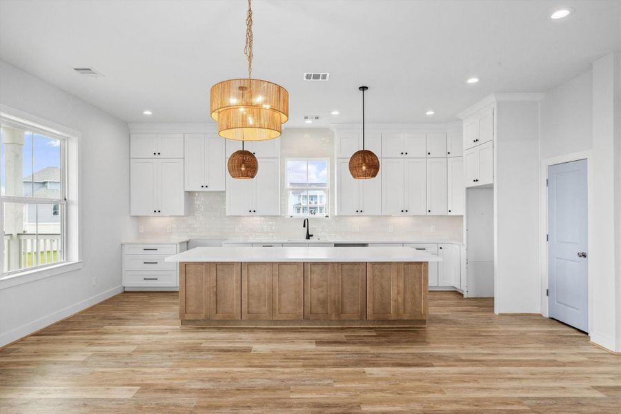Spacious kitchen featuring stylish two-tone cabinetry and abundant storage.