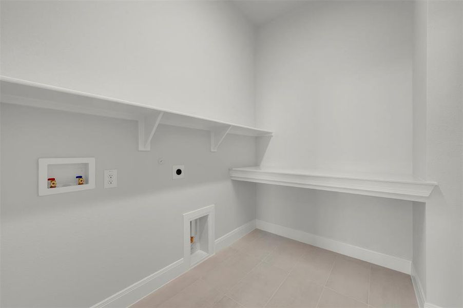 Laundry room with hookup for a washing machine, light tile patterned floors, gas dryer hookup, and hookup for an electric dryer