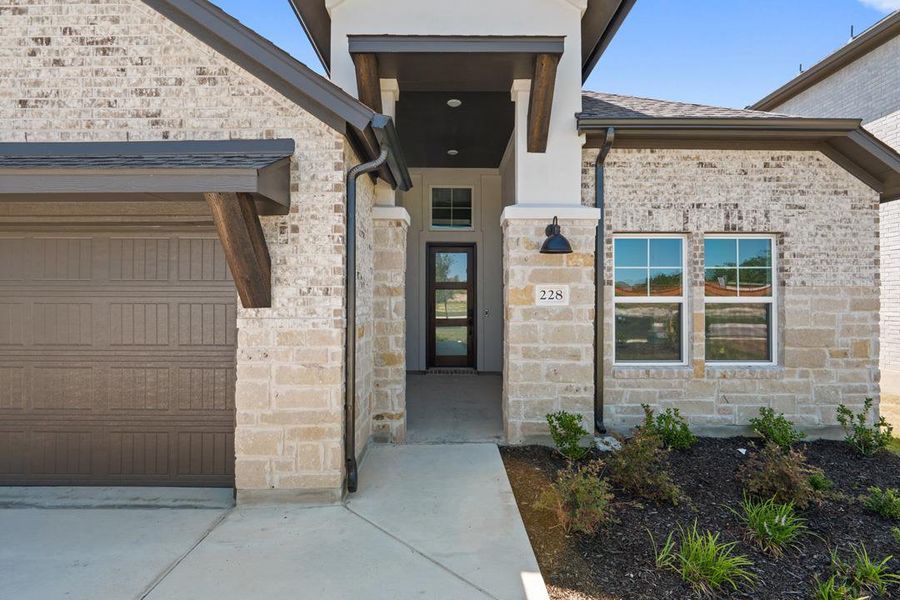 Front exterior of a new home in Park Collection at Lariat, Liberty Hill, TX, highlighting curb appeal (Image 1). Front exterior of a new home in Park Collection at Lariat, Liberty Hill, TX, highlighting curb appeal (Image 1).
