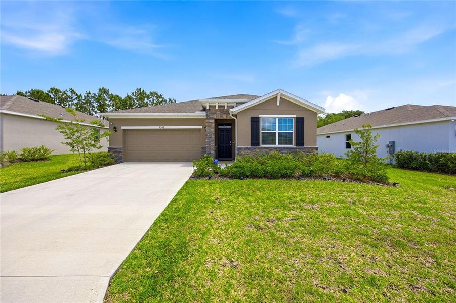 Front exterior of a new home in JB Ranch, Ocala, FL, highlighting curb appeal (Image 24).