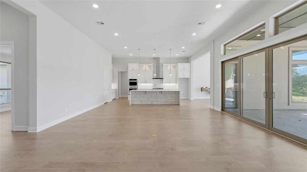 Unfurnished living room featuring recessed lighting and light wood-style flooring Unfurnished living room featuring recessed lighting and light wood-style flooring
