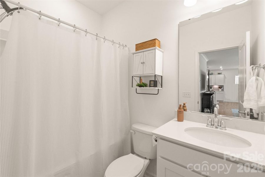 Full bathroom on the main floor is conveniently located next to main floor guestroom