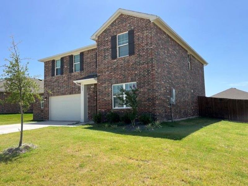 View of front facade with a garage and a front lawn