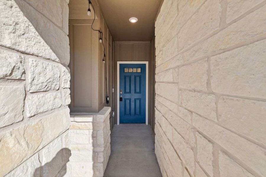 Property entrance featuring stone siding and board and batten siding Property entrance featuring stone siding and board and batten siding