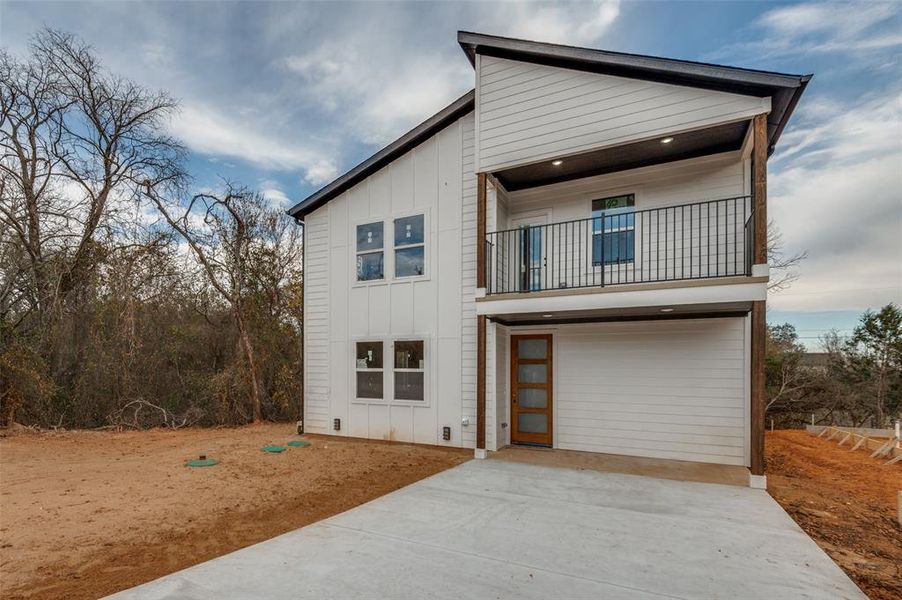 View of front of house with a balcony and a garage