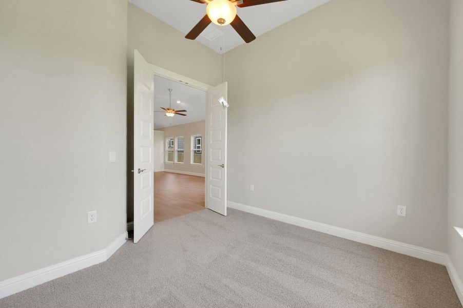 Unfurnished room featuring ceiling fan and carpet Unfurnished room featuring ceiling fan and carpet