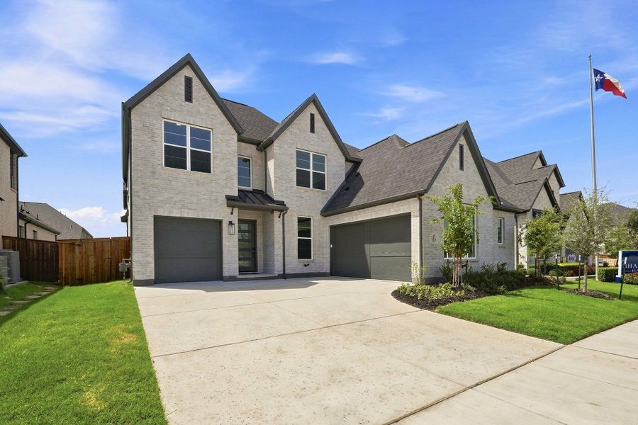 Front exterior of a new home in Estates at Rockhill, Frisco, TX, highlighting curb appeal (Image 2). Front exterior of a new home in Estates at Rockhill, Frisco, TX, highlighting curb appeal (Image 2).