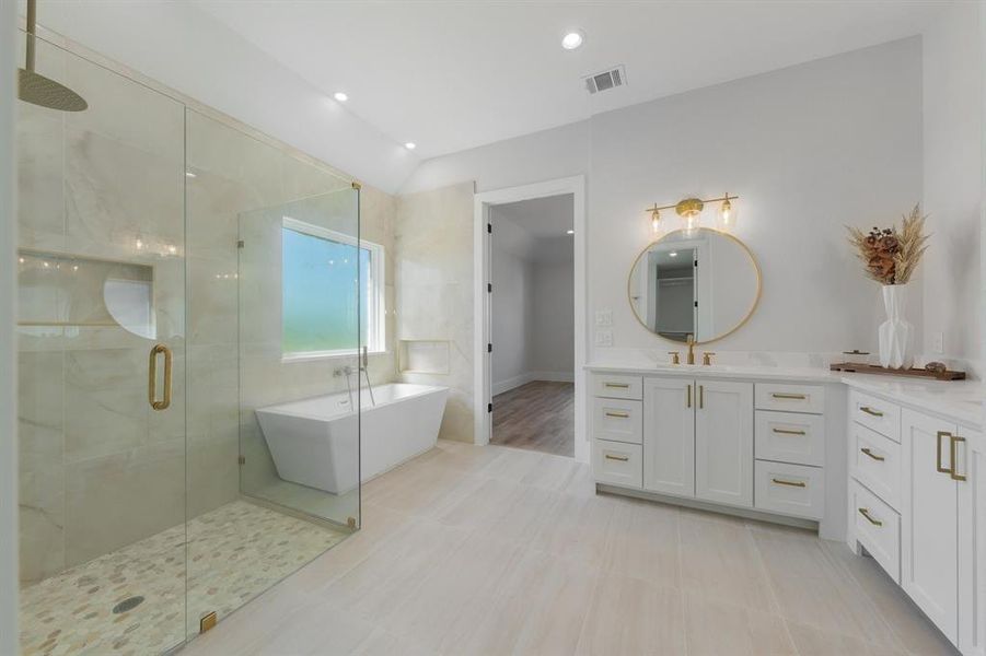 Full bath featuring vanity, a freestanding bathtub, a shower stall, and recessed lighting