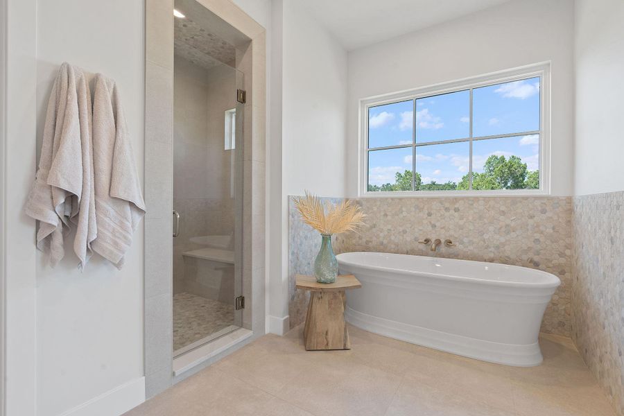 Bathroom featuring a soaking tub, tile patterned flooring, and a spacious walk in shower Bathroom featuring a soaking tub, tile patterned flooring, and a spacious walk in shower