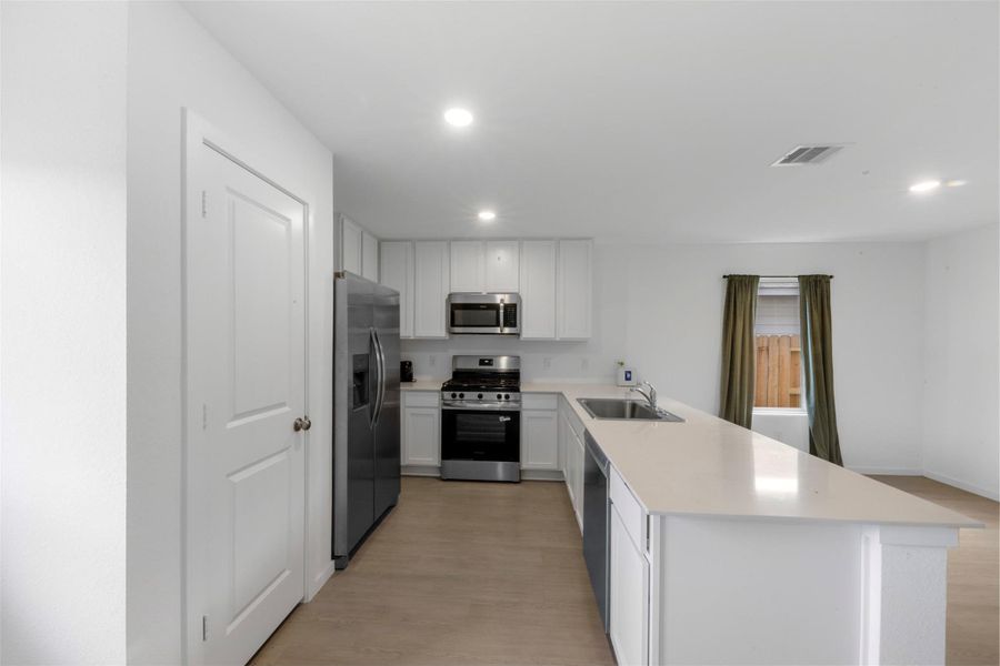 Kitchen view showcasing stainless steel appliances, all included!