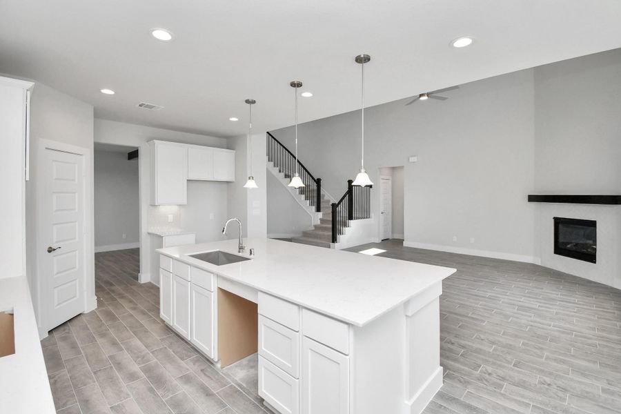 All of this overlooks your expansive family room, creating a perfect space for culinary delights and family gatherings. Sample photo of completed home with similar floor plan. Actual colors and selections may vary.