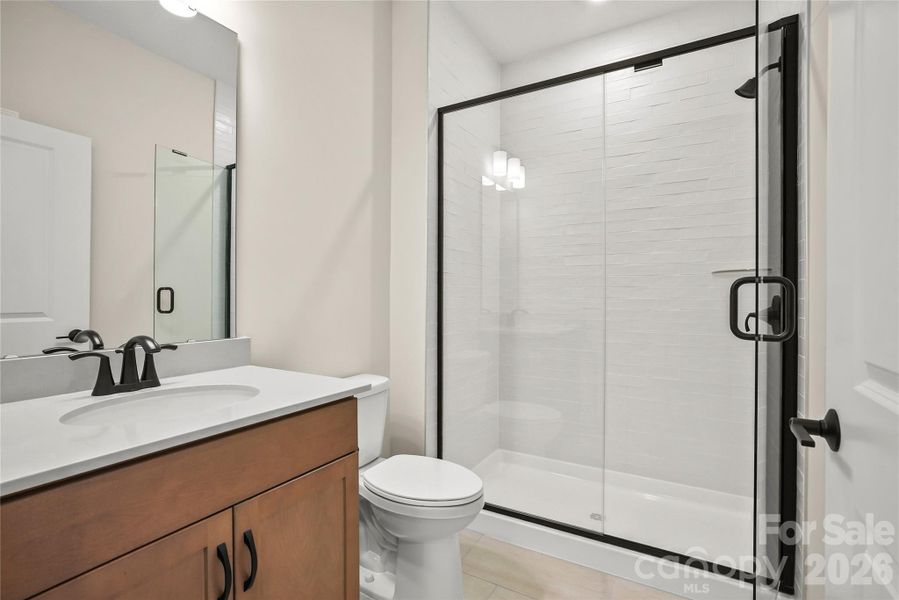 ...With shared bathroom featuring walk-in shower