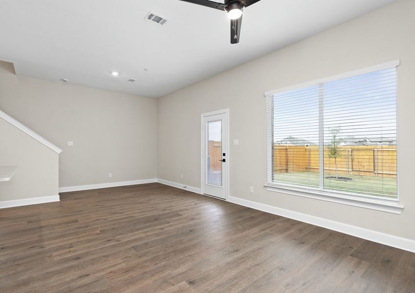 The living room has large windows that let in great, natural light.
