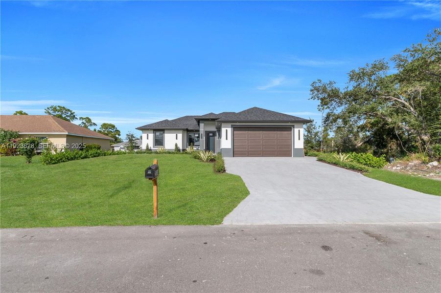 Front exterior of a new home in , Lehigh Acres, FL, highlighting curb appeal (Image 28).
