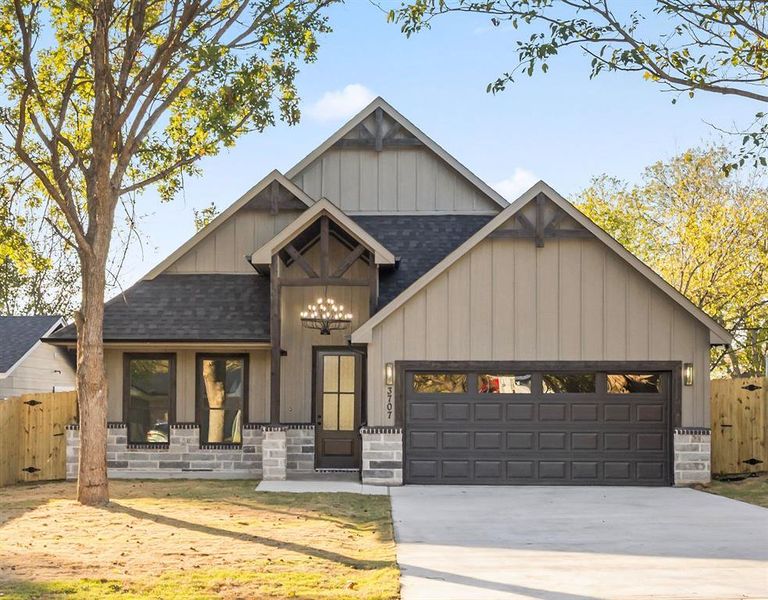 View of front of property with roof with shingles, board and batten siding, concrete driveway, and an attached garage View of front of property with roof with shingles, board and batten siding, concrete driveway, and an attached garage