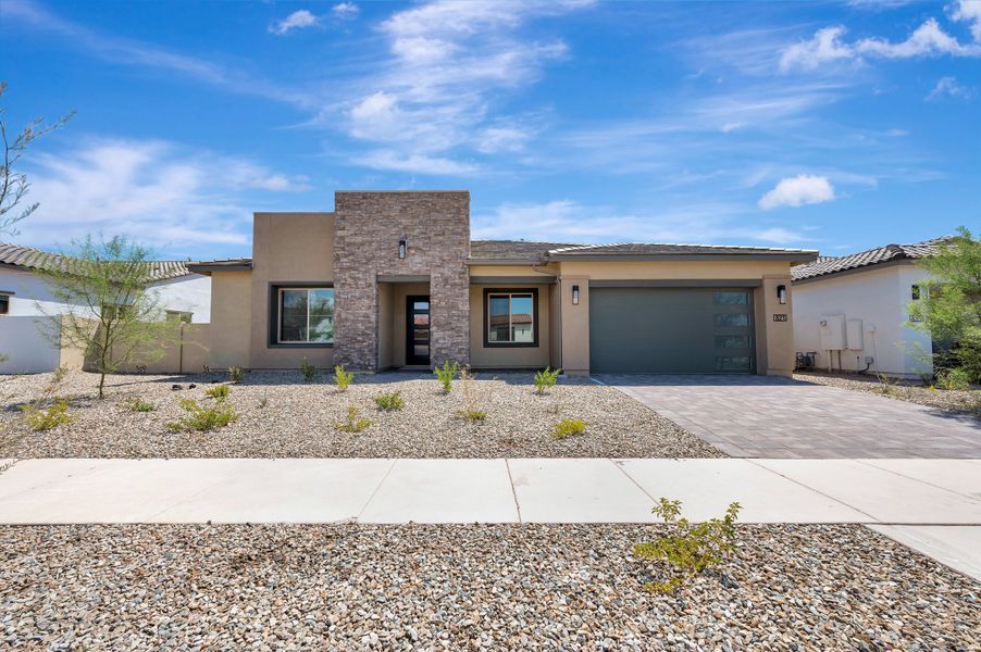 Front exterior of a new home in Blossom Rock, Apache Junction, AZ, highlighting curb appeal (Image 2). Front exterior of a new home in Blossom Rock, Apache Junction, AZ, highlighting curb appeal (Image 2).