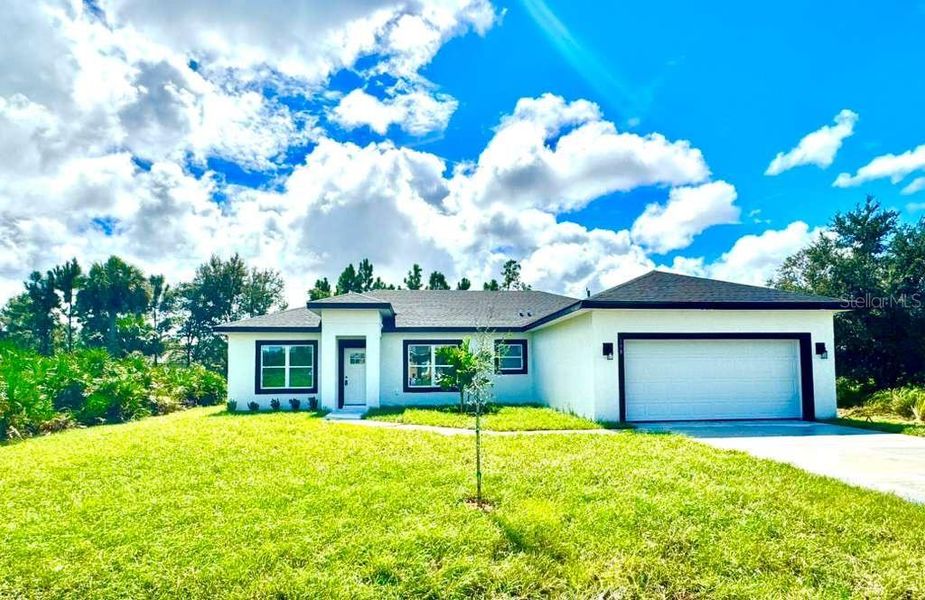 Front exterior of a new home in , Palm Bay, FL, highlighting curb appeal (Image 28).