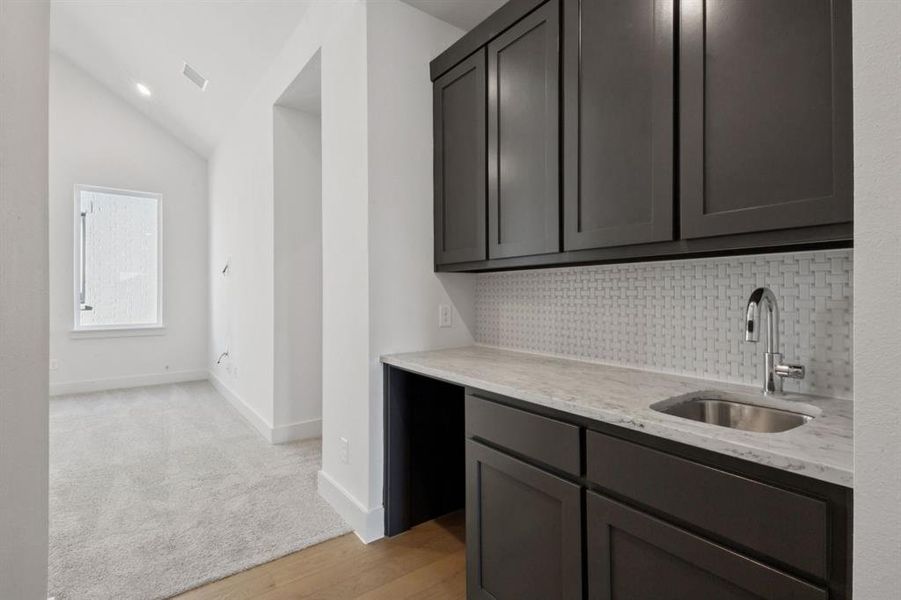 The wet bar area just off the game room is beautiful and functional.