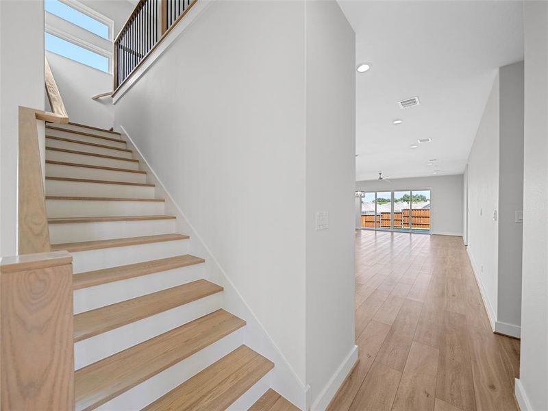 Stairs featuring wood-type flooring