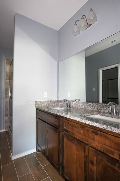 Bathroom featuring vanity and an enclosed shower