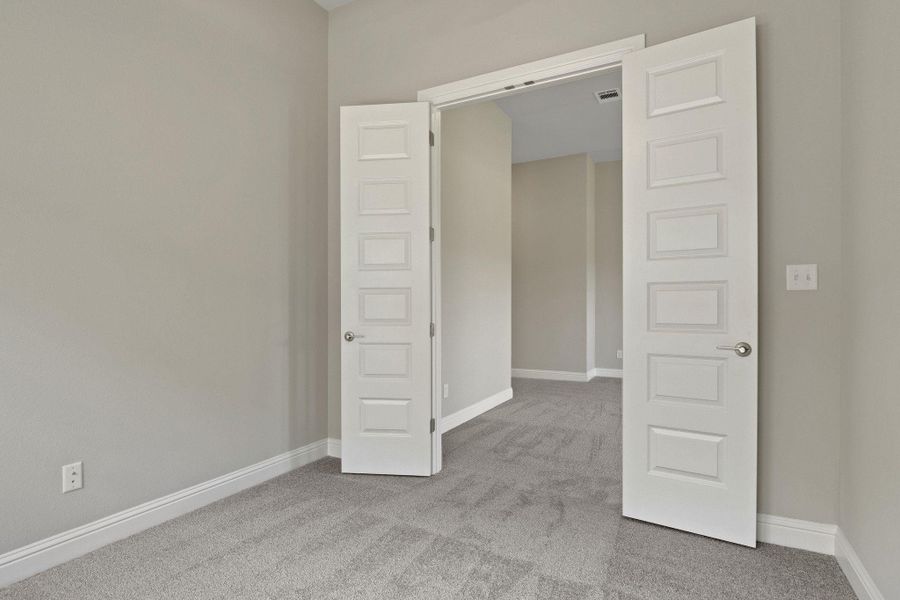 Unfurnished room with baseboards and carpet