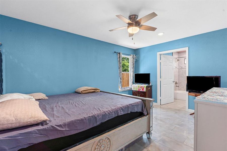 Bedroom featuring a ceiling fan, ensuite bath, and recessed lighting Bedroom featuring a ceiling fan, ensuite bath, and recessed lighting