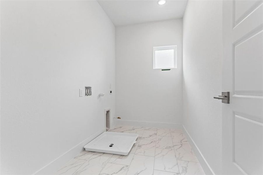 Laundry room with hookup for a gas dryer, electric dryer hookup, washer hookup, and light tile patterned floors