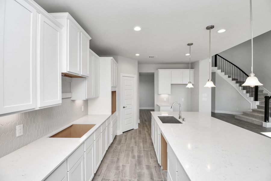 The extended counter area adds both practicality and style, making meal preparation a breeze. Every detail is thoughtfully designed to enhance the kitchen's functionality and aesthetic appeal. Sample photo of completed home with similar floor plan. Actual colors and selections may vary.