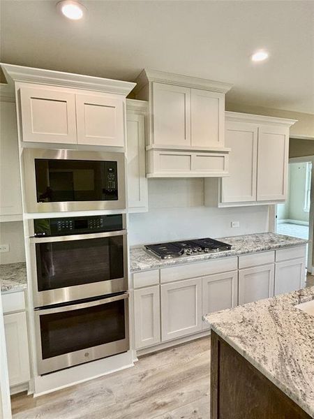 Full bath featuring marble finish flooring and a soaking tub Full bath featuring marble finish flooring and a soaking tub
