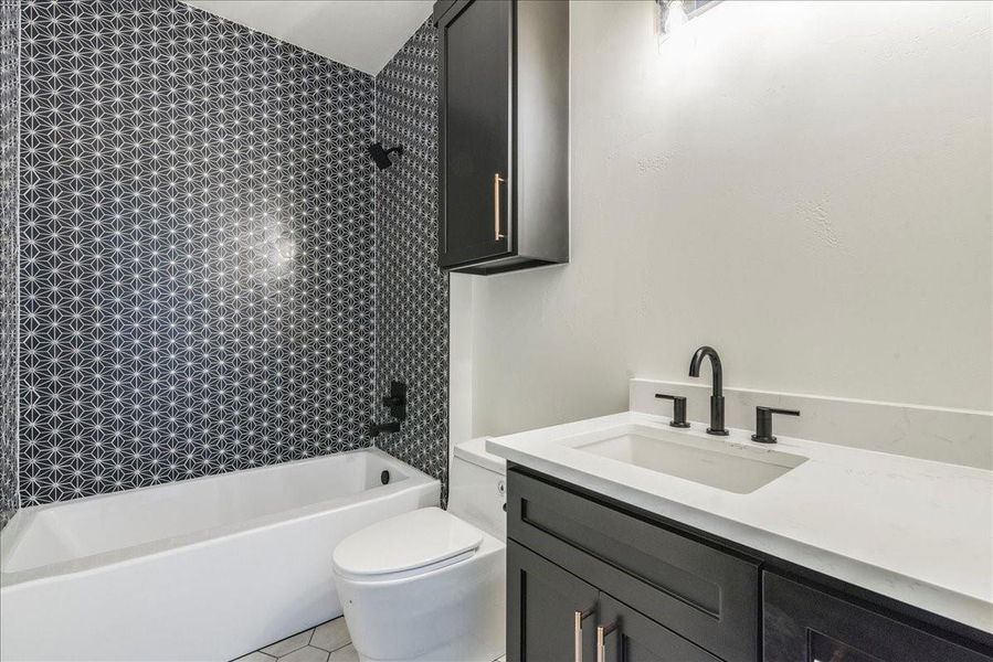 The well-appointed full bath is conveniently located in the hallway, providing easy access for both the office and guests.