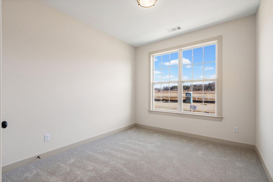 Carpeted spare room with baseboards